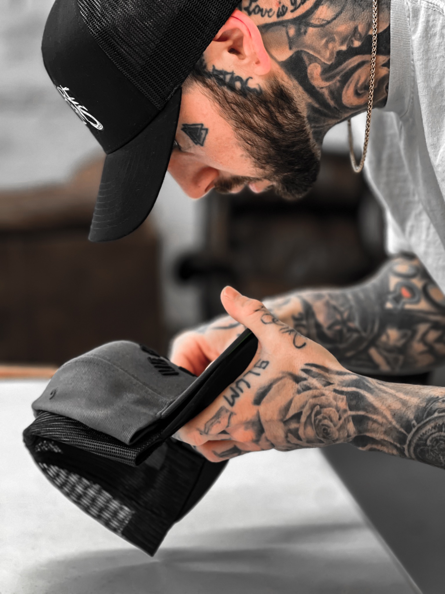 Alex carefully working on a hat at Villains Print Lab