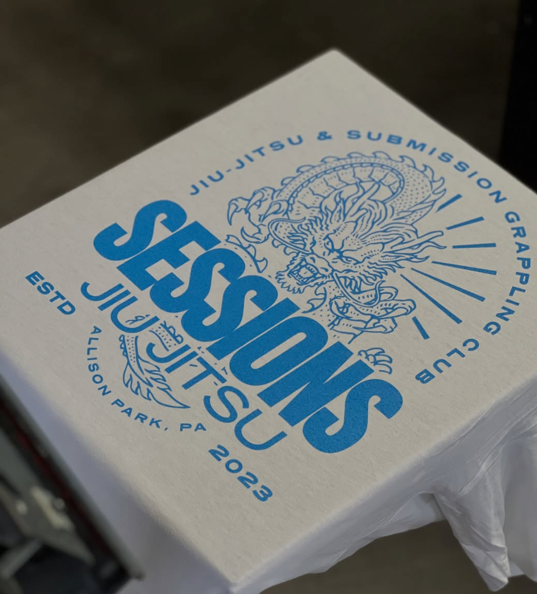Blue Sessions Jiu-Jitsu dragon graphic printed on white apparel