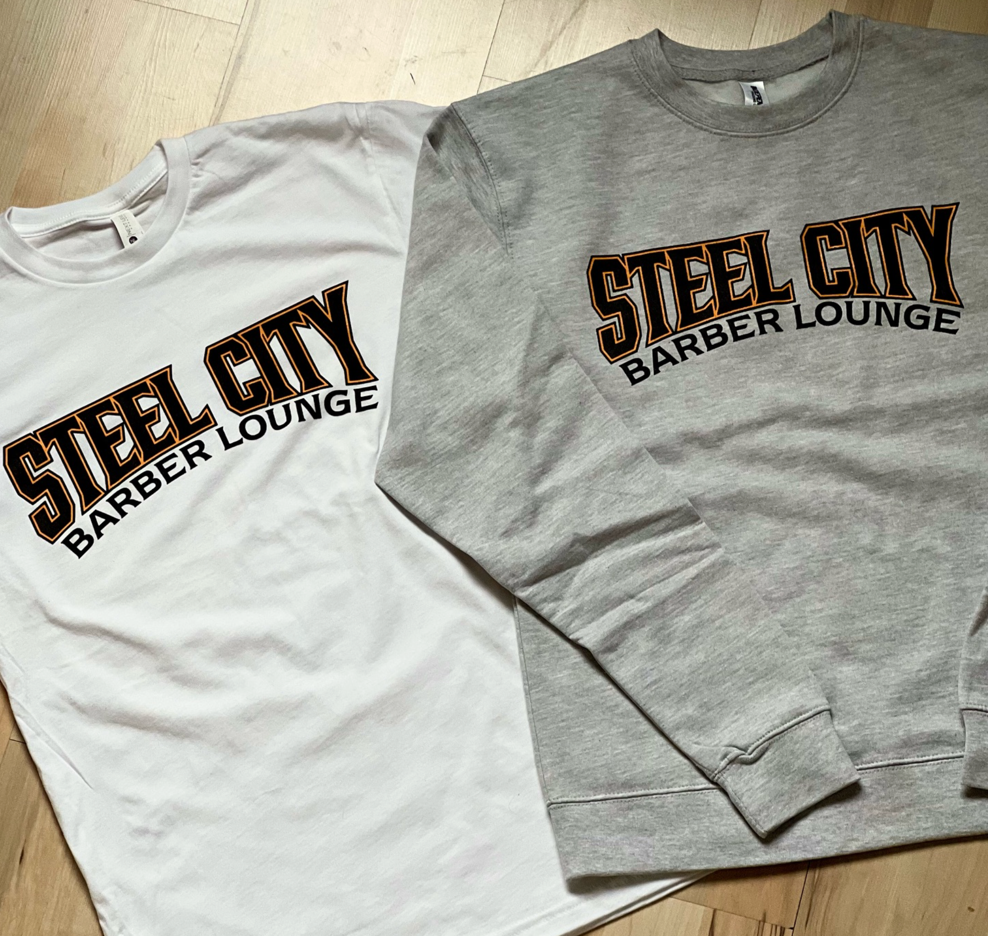 Steel City Barber Lounge logos printed on white and gray apparel